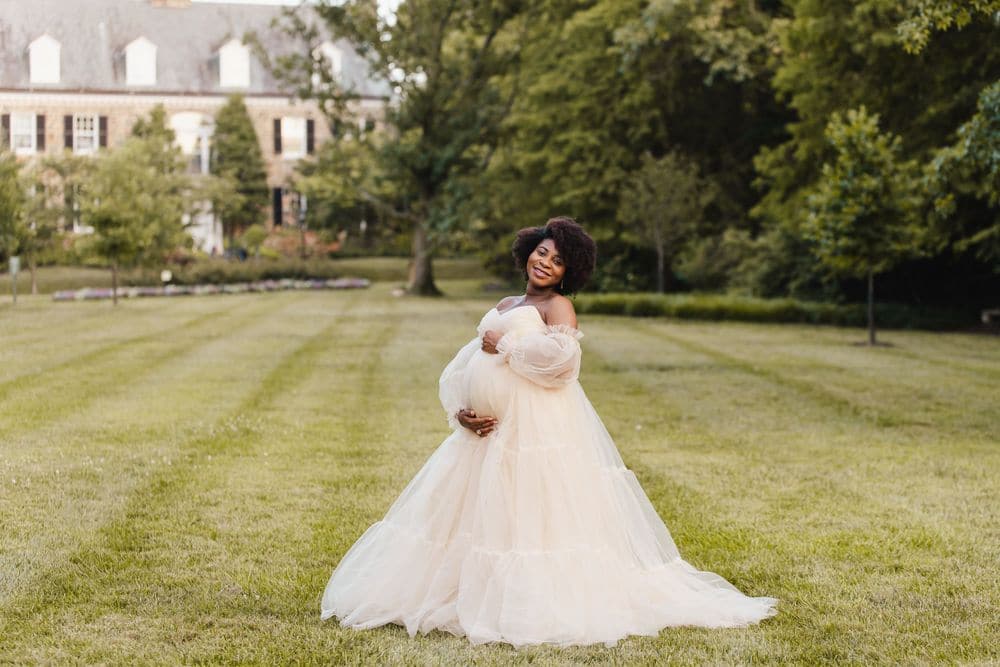 Maternity photography session in a rented cream gown on a manor lawn by Create With Amy in Maryland